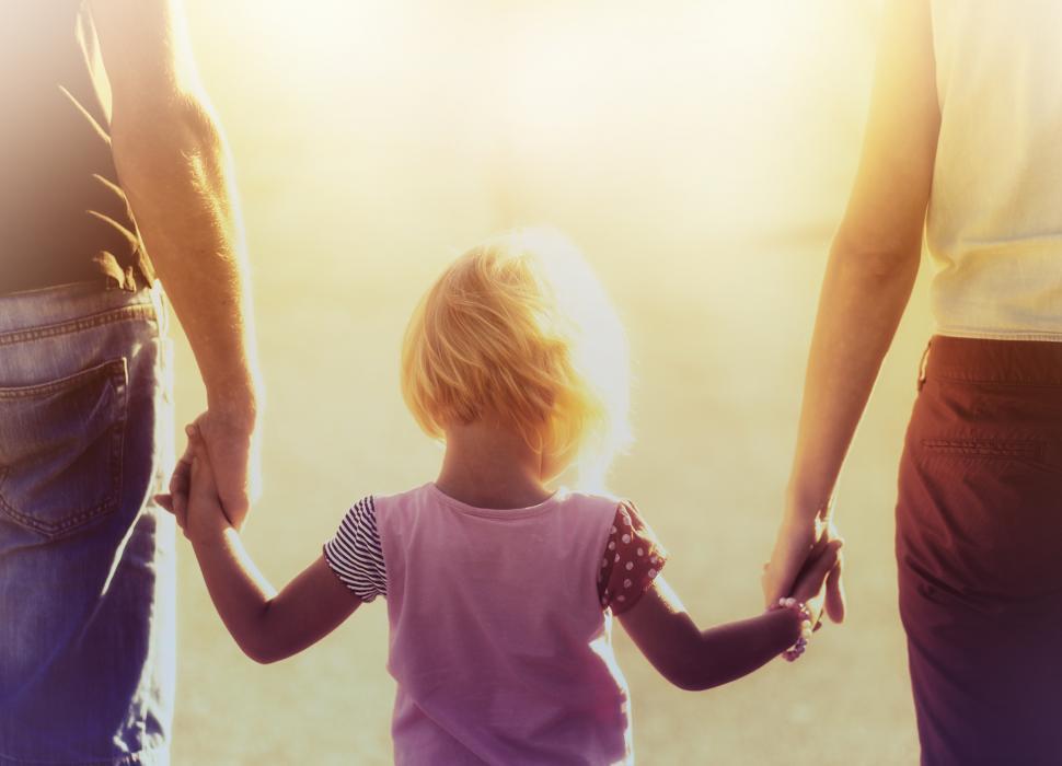 into-the-light--parents-hold-hands-with-small-child